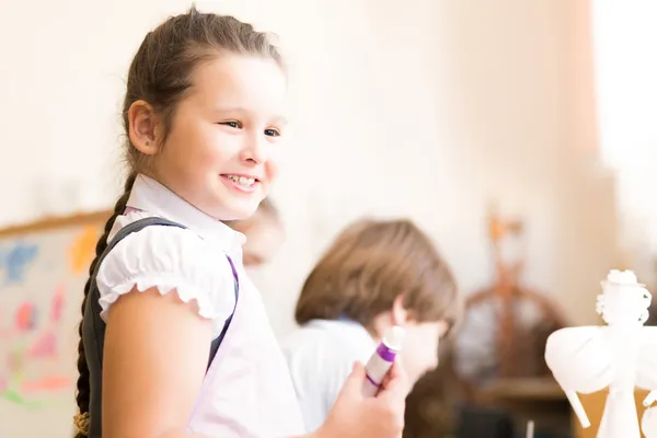 Portrait of Asian girl in apron painting — Stock Photo, Image