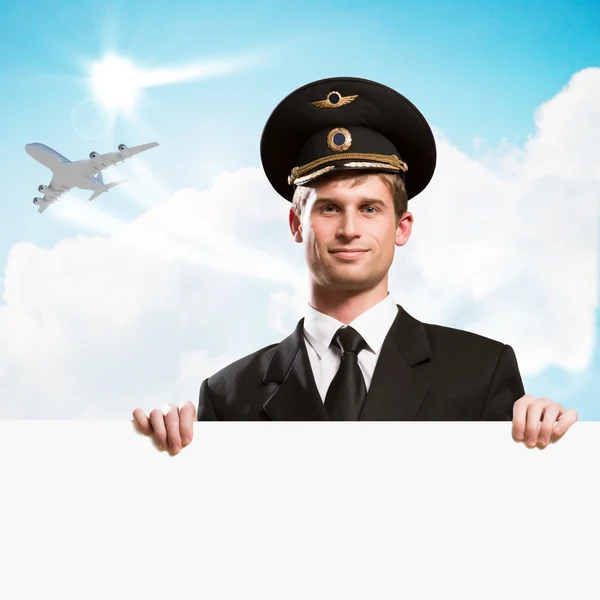 Pilot in the form of holding an empty billboard — Stock Photo, Image