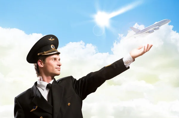 Pilot in the form of extending a hand to airplane — Stock Photo, Image