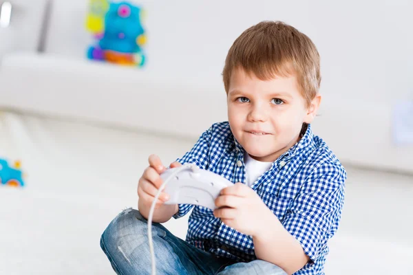 Boy playing on a game console — Stock Photo, Image