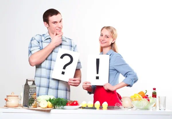 Couple holding a plate with signs — Stock Photo, Image