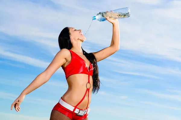 Sport girl in red uniform with a bottle of water — Stock Photo, Image