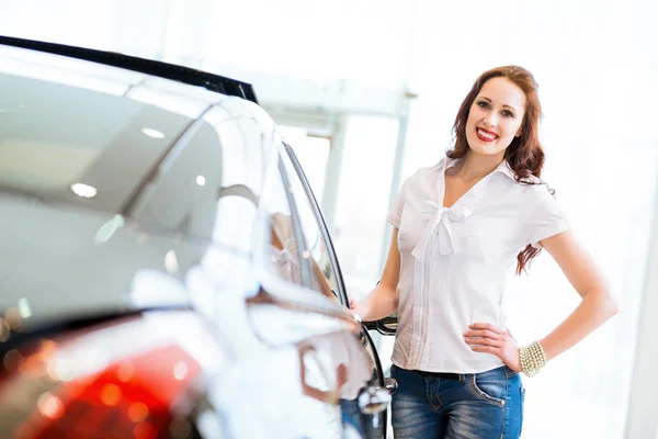 Young woman standing near a car Stock Photo