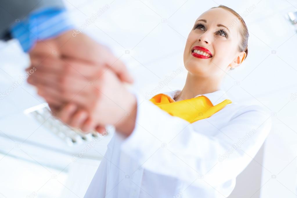 business woman shaking hands with a client