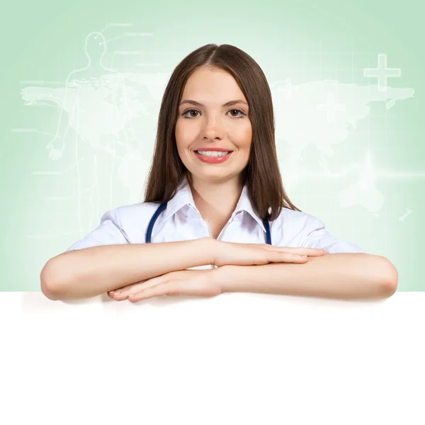 Young woman doctor with a blank banner — Stock Photo, Image