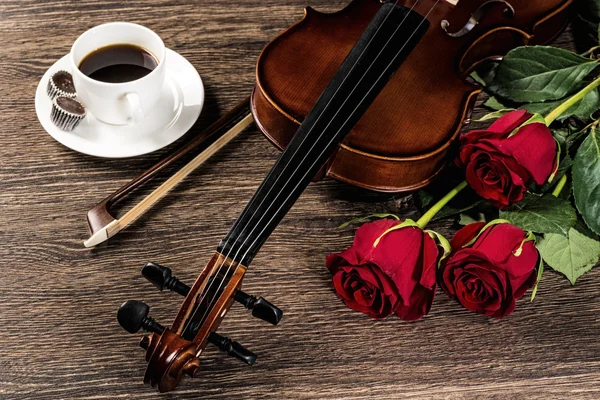 Violin, rose, coffee and music books