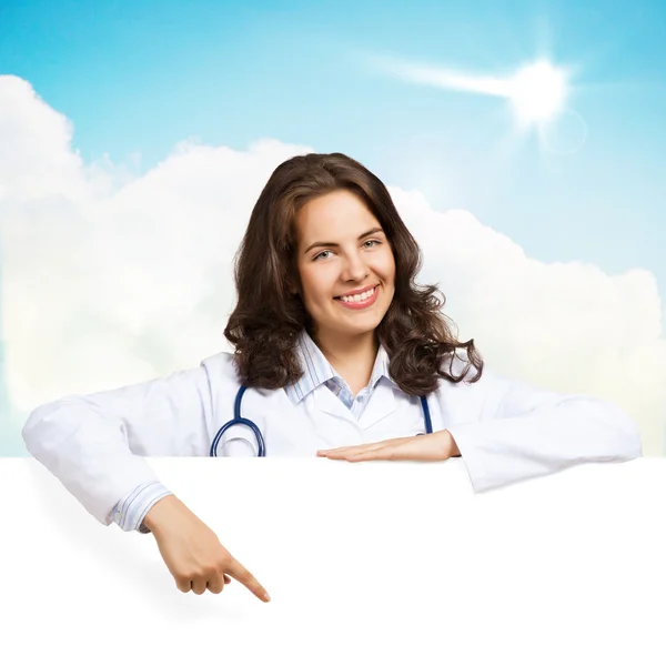 Young woman doctor with a blank banner — Stock Photo, Image