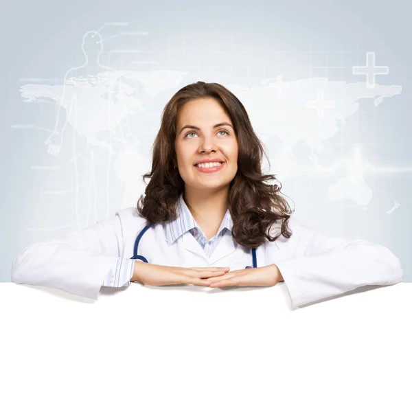 Young woman doctor with a blank banner — Stock Photo, Image