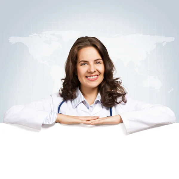 Young woman doctor with a blank banner — Stock Photo, Image