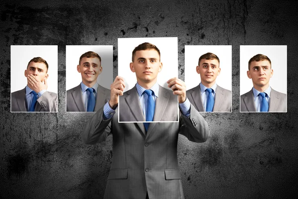 Young man holds up a photograph — Stock Photo, Image