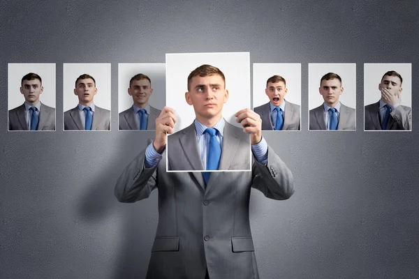 Young man holds up a photograph — Stock Photo, Image