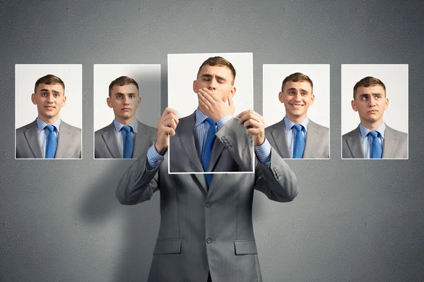 Young man holds up a photograph — Stock Photo, Image