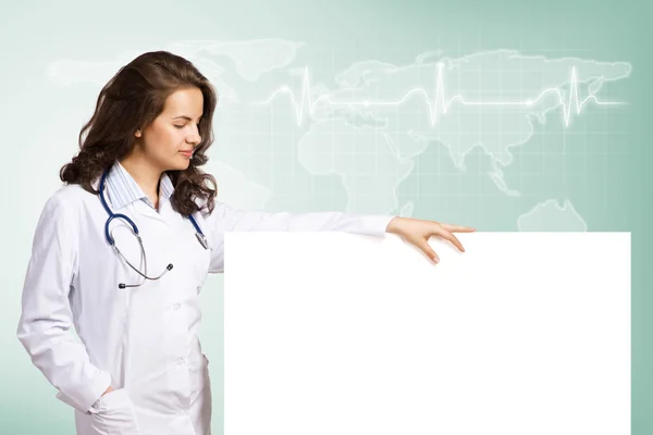 Young woman doctor with a blank banner — Stock Photo, Image