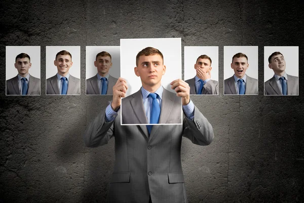 Young man holds up a photograph — Stock Photo, Image