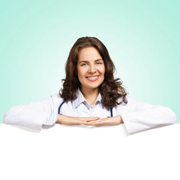 Young woman doctor with a blank banner — Stock Photo, Image