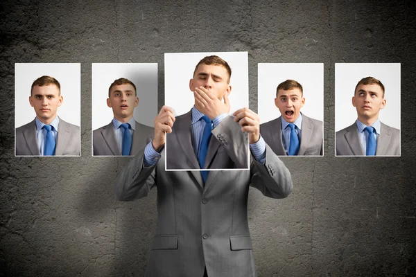 Young man holds up a photograph — Stock Photo, Image