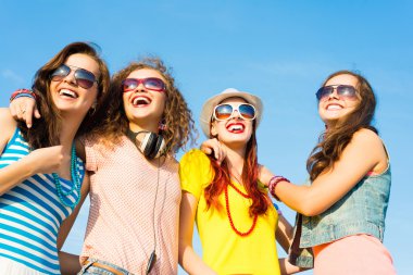 group of young people wearing sunglasses and hat