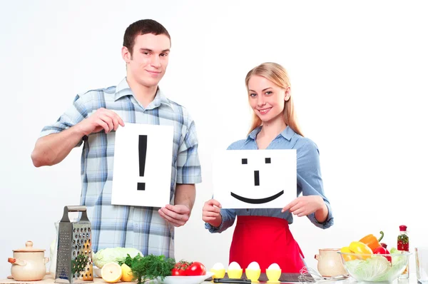 Couple holding a plate with signs — Stock Photo, Image