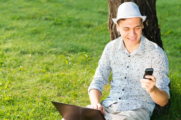 Young man with a cell phone — Stock Photo, Image