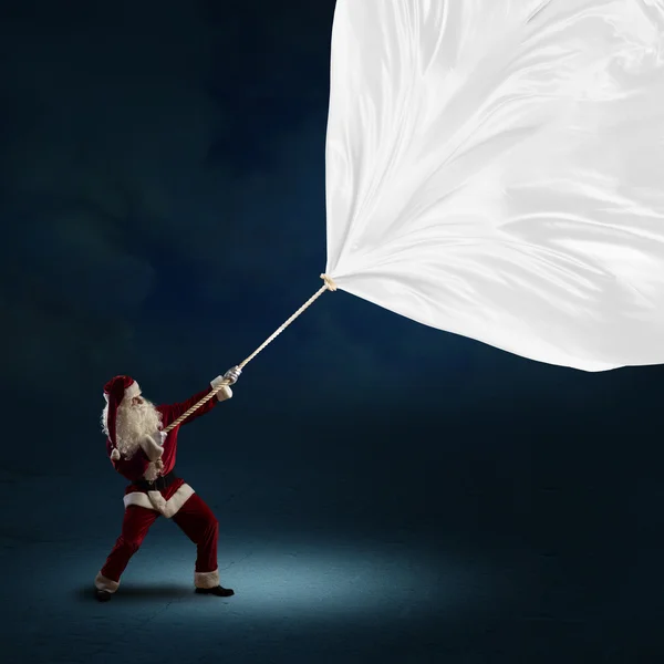 Santa Claus pulls the banner — Stock Photo, Image