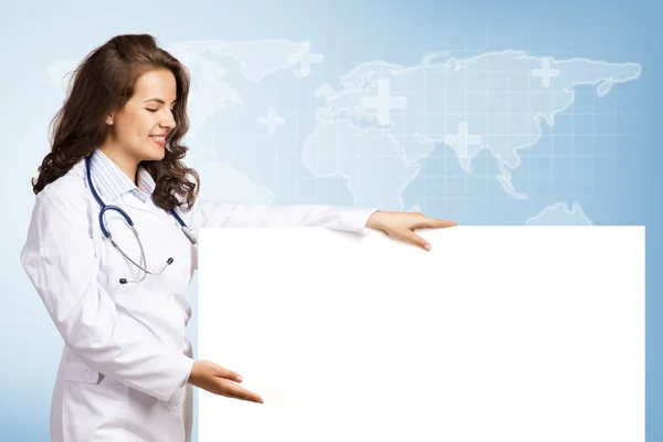 Young woman doctor with a blank banner — Stock Photo, Image