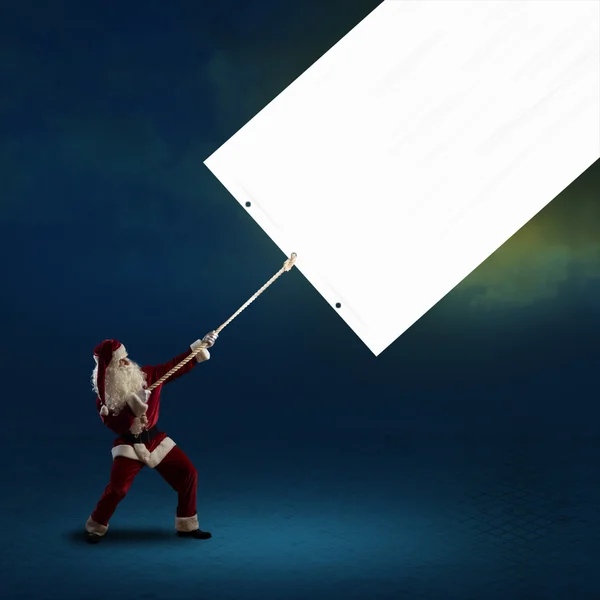 Santa Claus pulls the banner — Stock Photo, Image