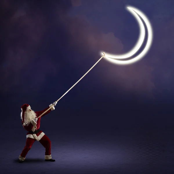 Santa Claus pulls the moon — Stock Photo, Image