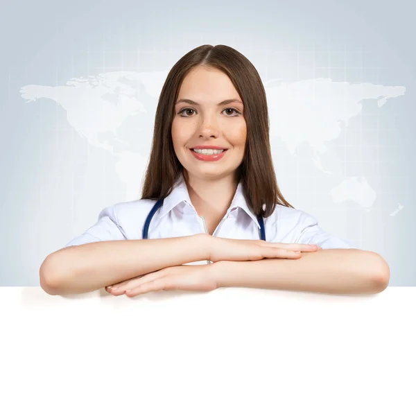 Young woman doctor with a blank banner — Stock Photo, Image