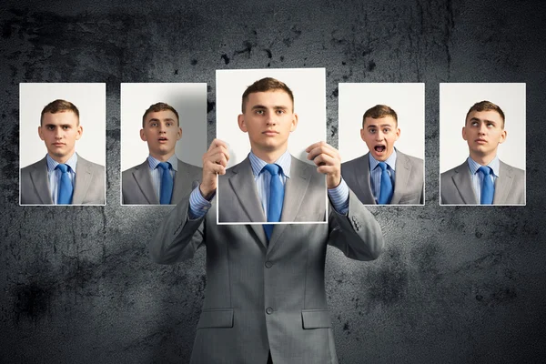 Young man holds up a photograph — Stock Photo, Image