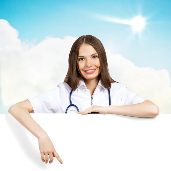 Young woman doctor with a blank banner — Stock Photo, Image