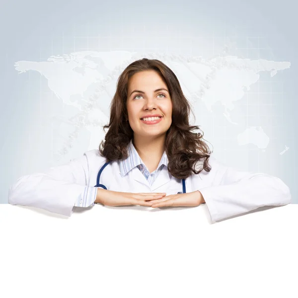 Young woman doctor with a blank banner — Stock Photo, Image