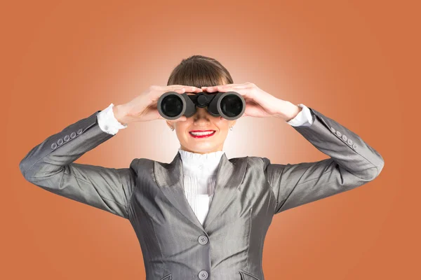 Business woman looking through binoculars — Stock Photo, Image
