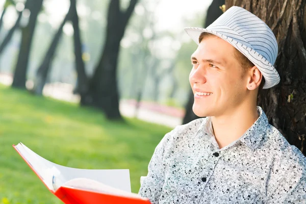 Unge man läser en bok — Stockfoto