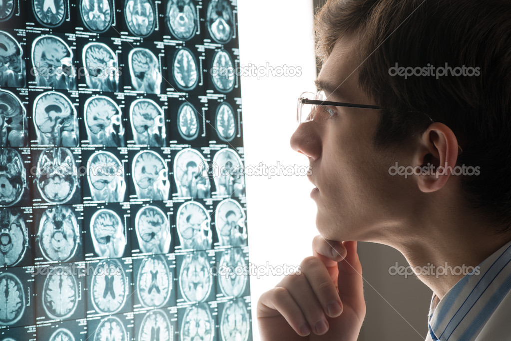 male doctor looking at the x-ray image