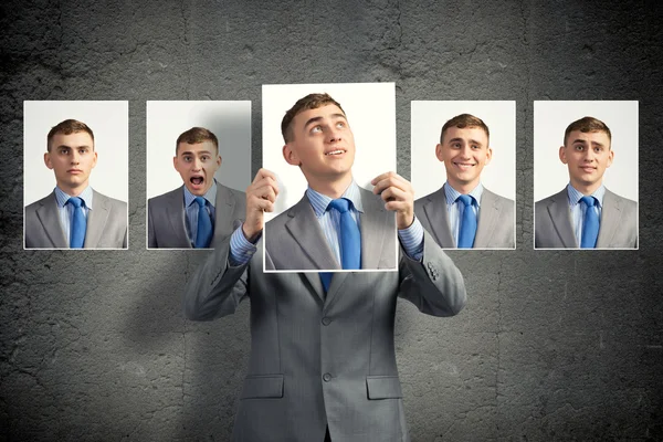 Young man holds up a photograph — Stock Photo, Image