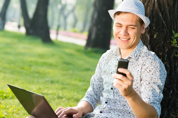 Young man with a cell phone — Stock Photo, Image