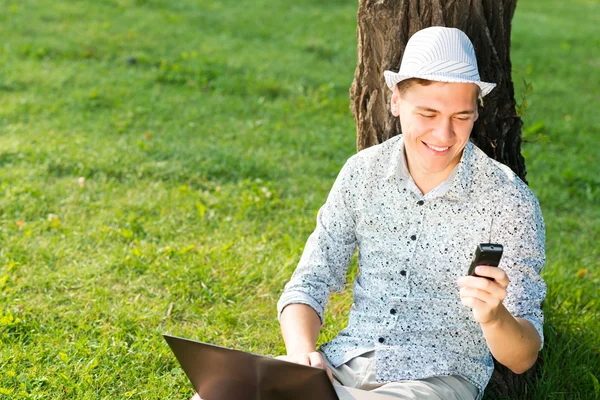Young man with a cell phone — Stock Photo, Image