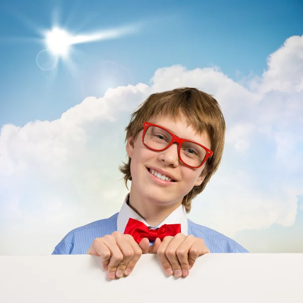 Boy holding a white banner — Stock Photo, Image
