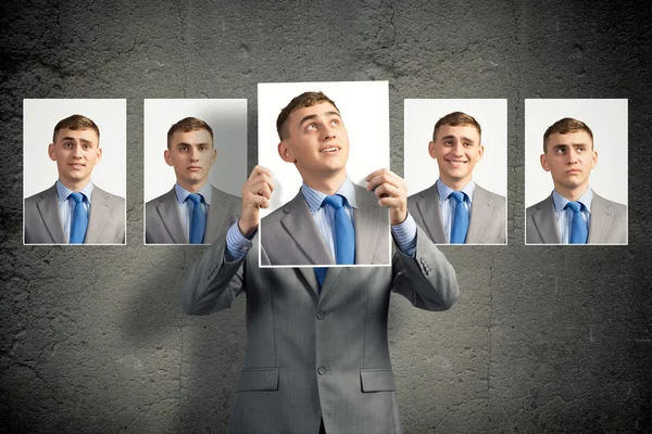 Young man holds up a photograph — Stock Photo, Image