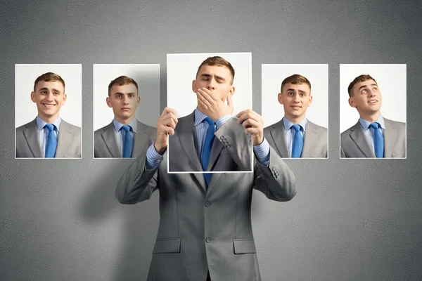 Young man holds up a photograph — Stock Photo, Image