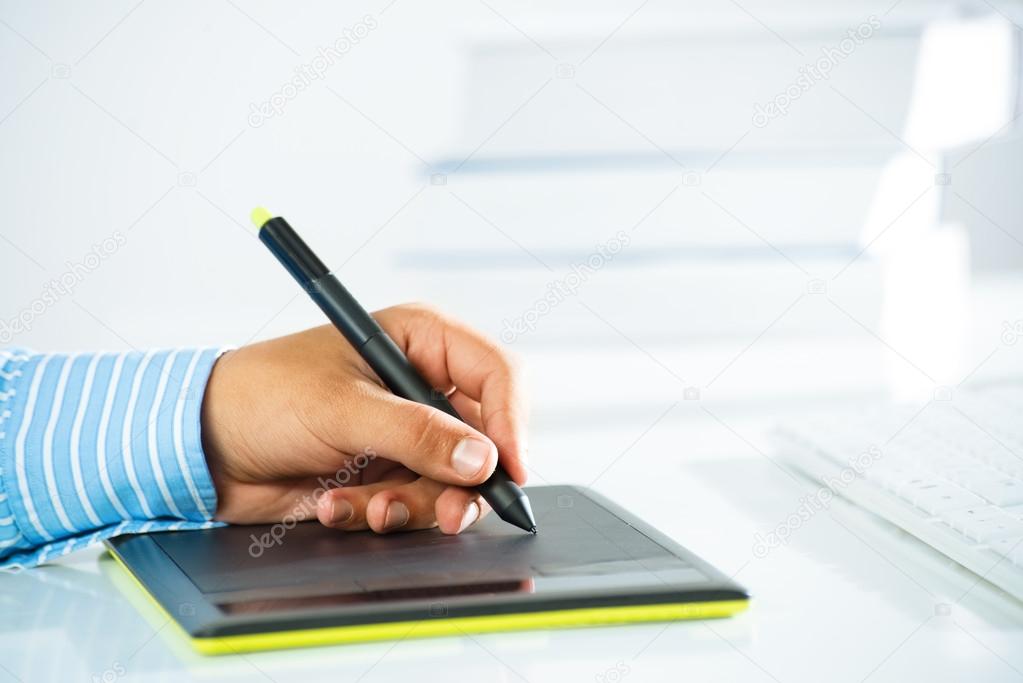 man's hand with a pen