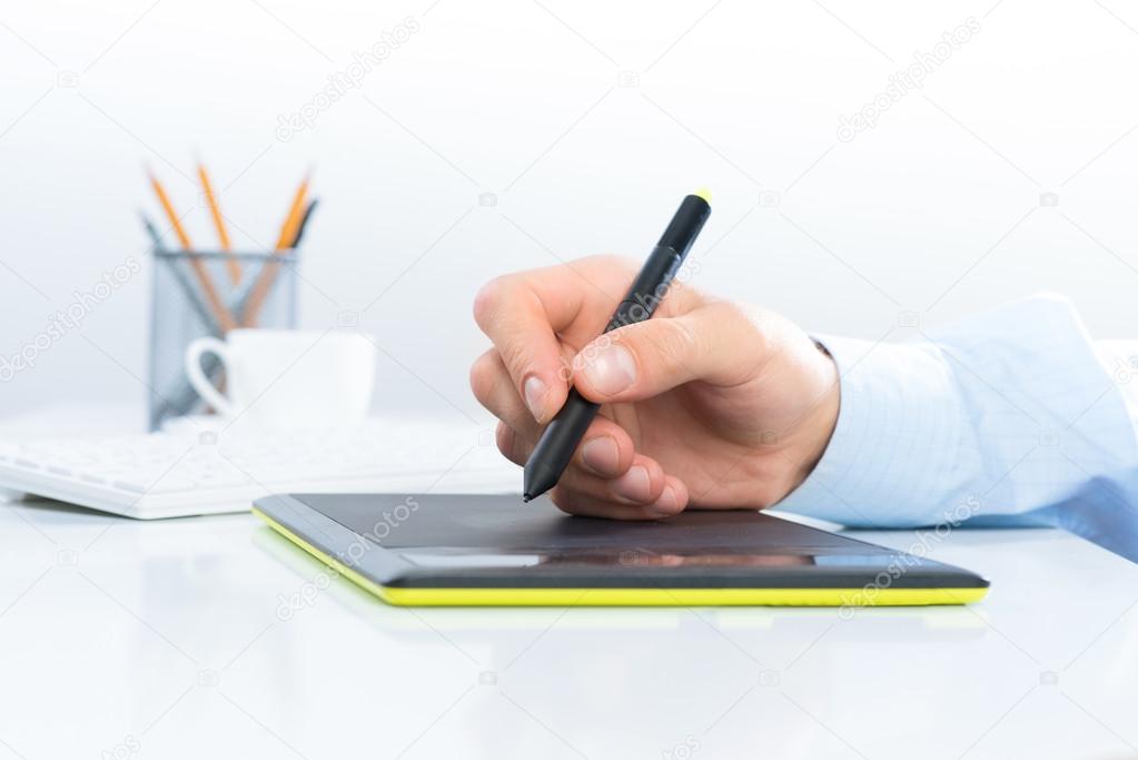 Designer hand on the tablet