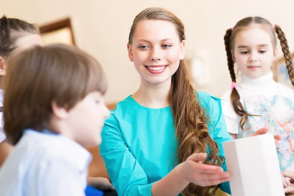 Children with the teacher engaged in painting — Stock Photo, Image
