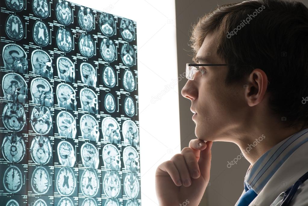 male doctor looking at the x-ray image