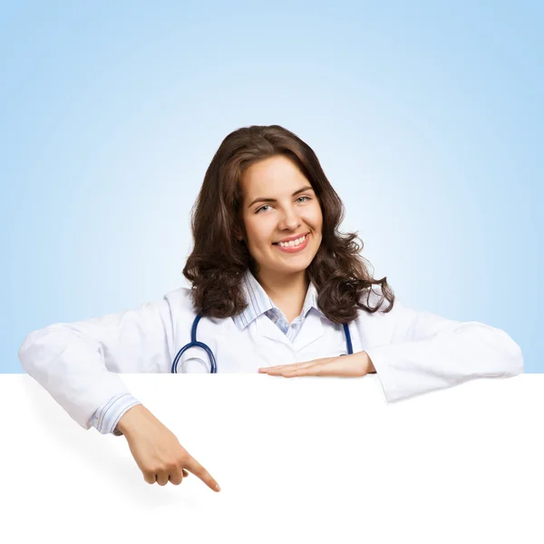 Young woman doctor with a blank banner — Stock Photo, Image