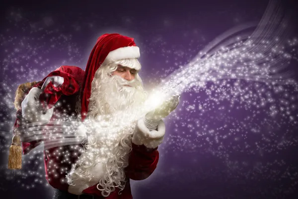 Santa Claus blows magic sparks — Stock Photo, Image