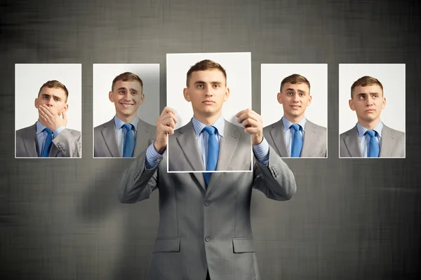 Young man holds up a photograph — Stock Photo, Image