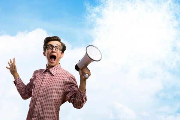 Young man shouting using megaphone — Stock Photo, Image