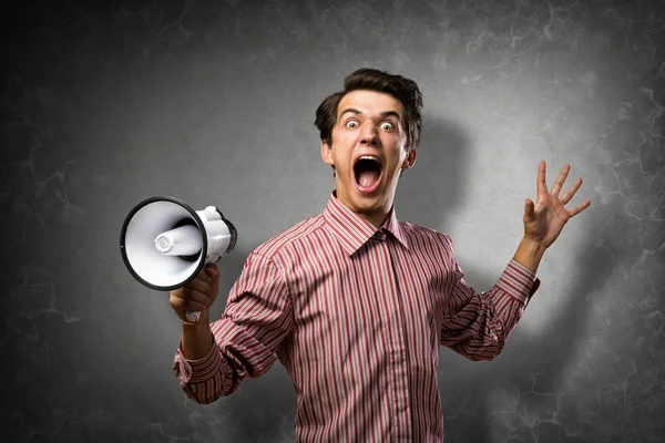 Mladý muž křičí, pomocí megafon — Stock fotografie