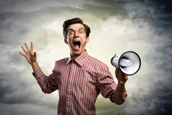 Young man shouting using megaphone — Stock Photo, Image